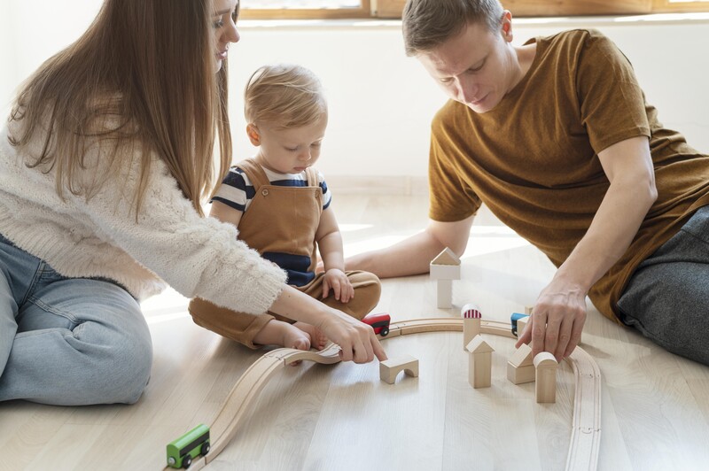 close-up-parents-playing-with-kid