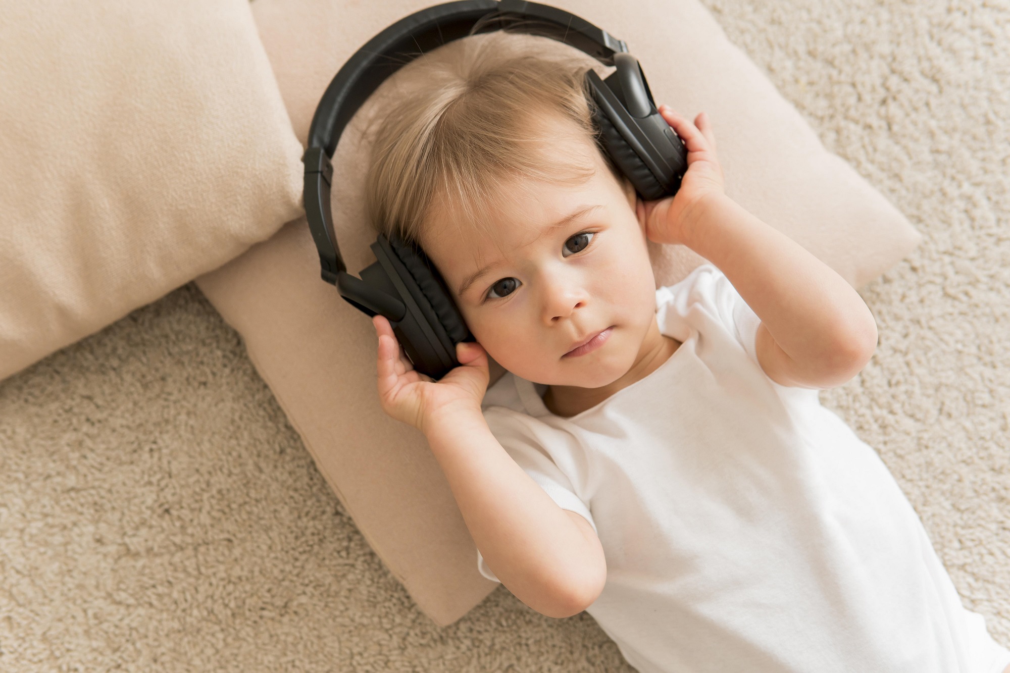 top-view-cute-baby-wearing-headphones