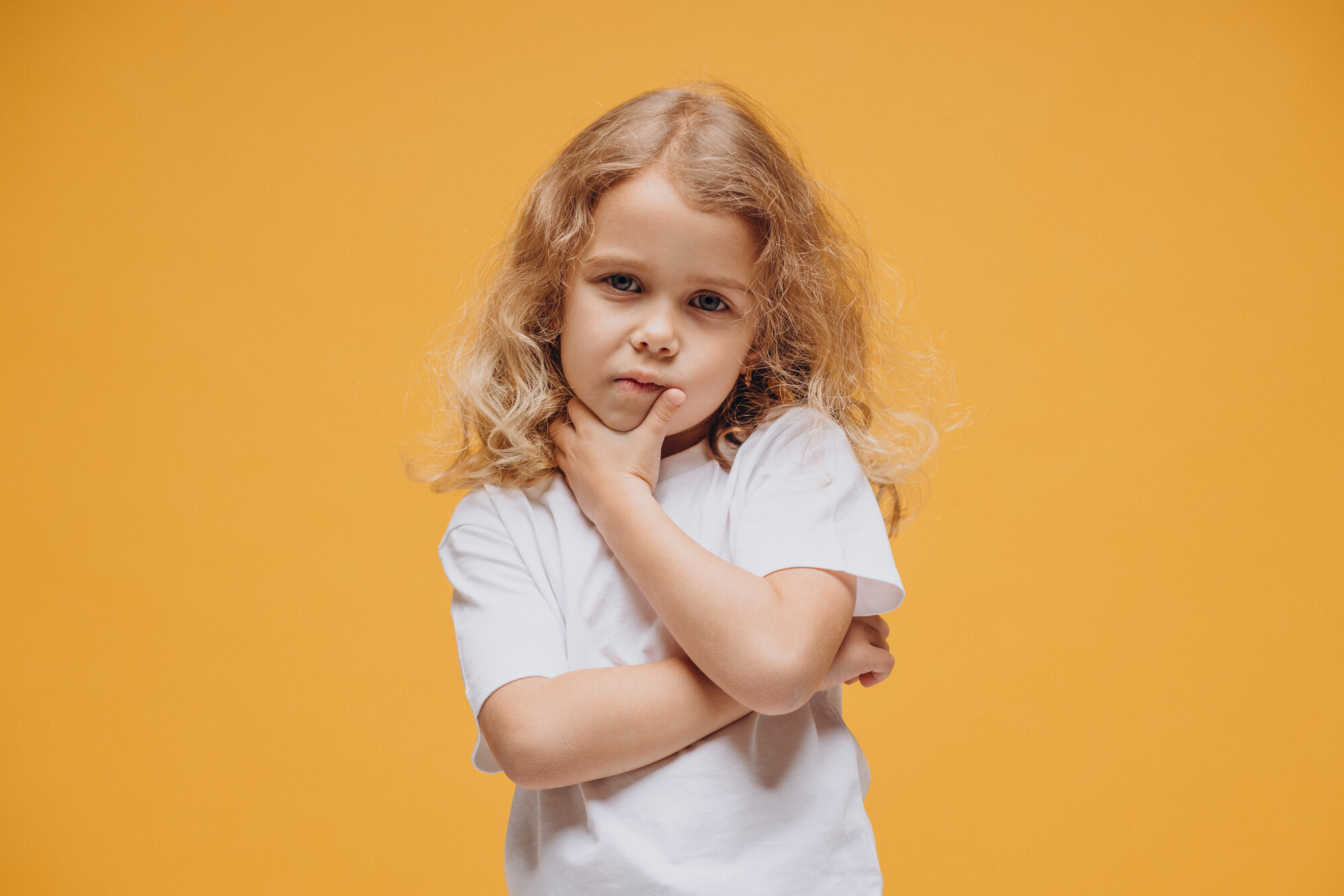 cute-little-girl-showing-emotions-isolated-yellow-background