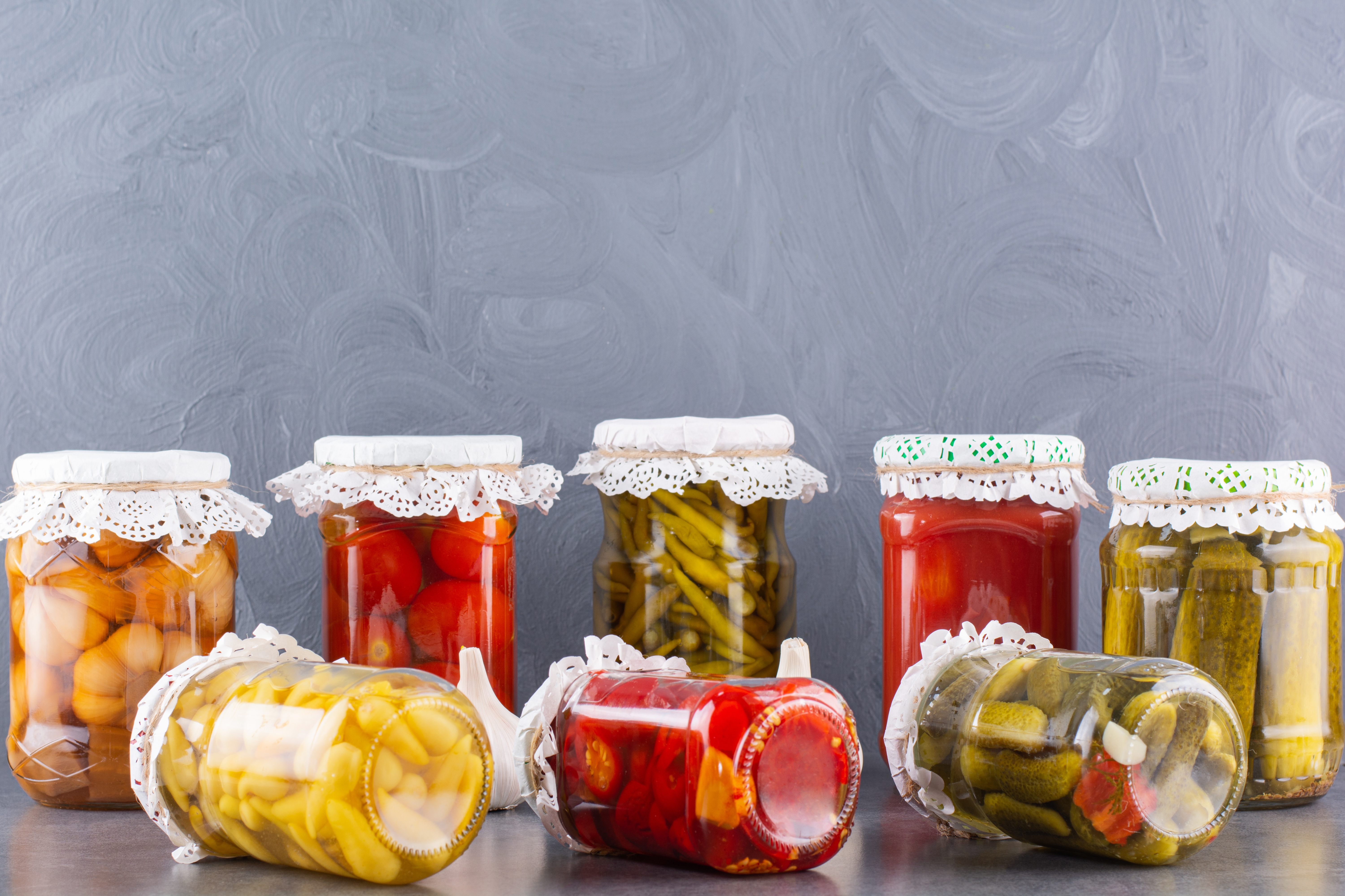 glass-jars-pickled-cucumbers-tomatoes-stone-table